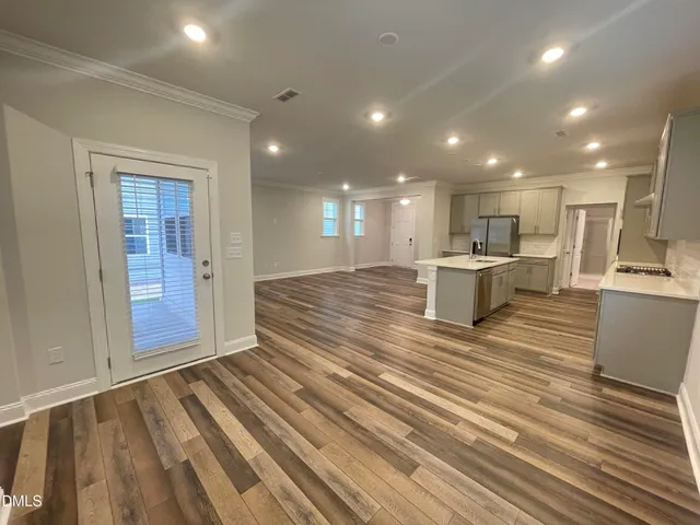 a bedroom with a large bed and potted plant