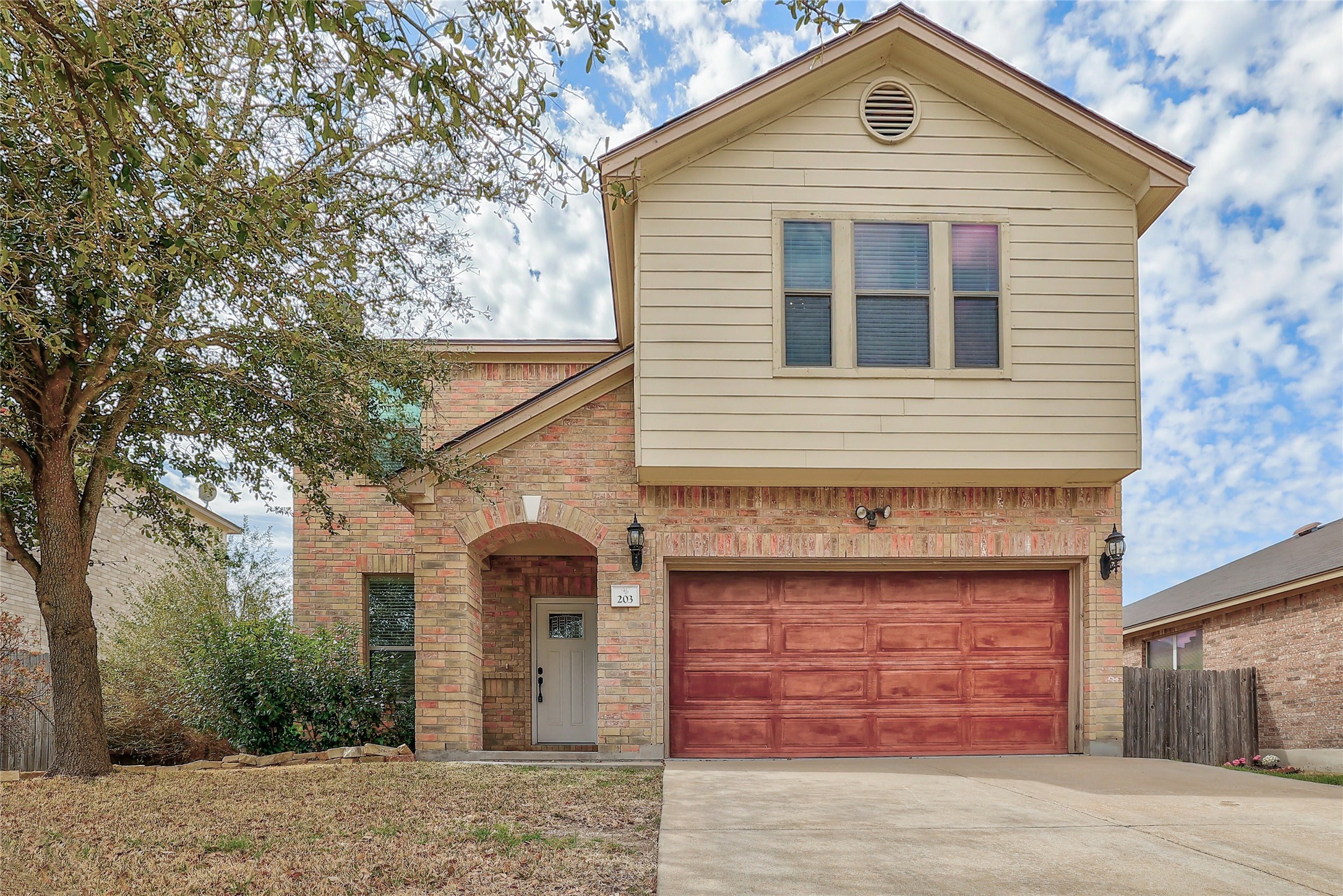 203 Ran Road Leander, TX 78641 - Photo 1 of 31 A two-story facade blends classic brickwork with horizontal siding above an arched entry.