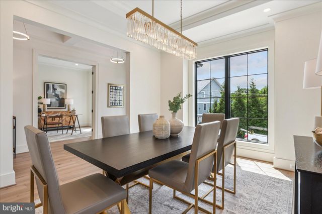 a large kitchen with kitchen island a large counter top space appliances and a ceiling fan