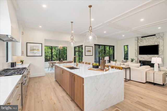 a kitchen with a stove a table and chairs in it