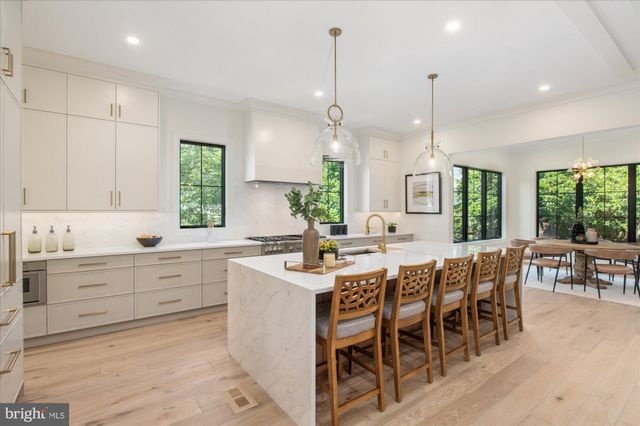 a kitchen with a table chairs stove and wooden floor
