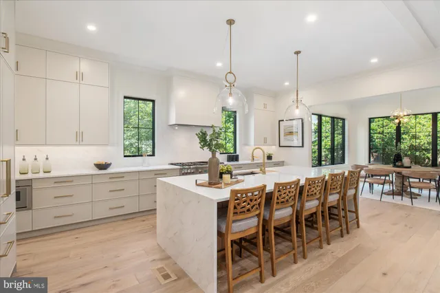 a kitchen with a table chairs stove and wooden floor