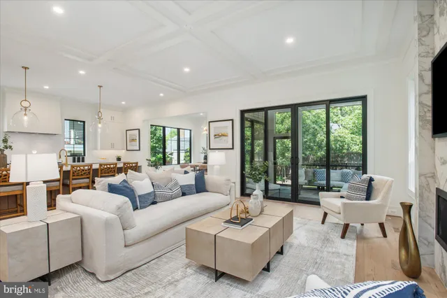 a dining room with furniture a chandelier and wooden floor