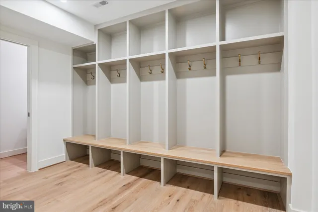 a bathroom with a sink toilet double vanity and shower