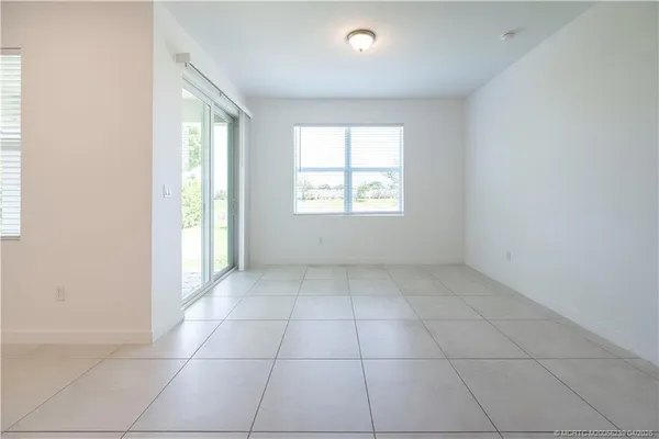 an empty room with a empty space and windows