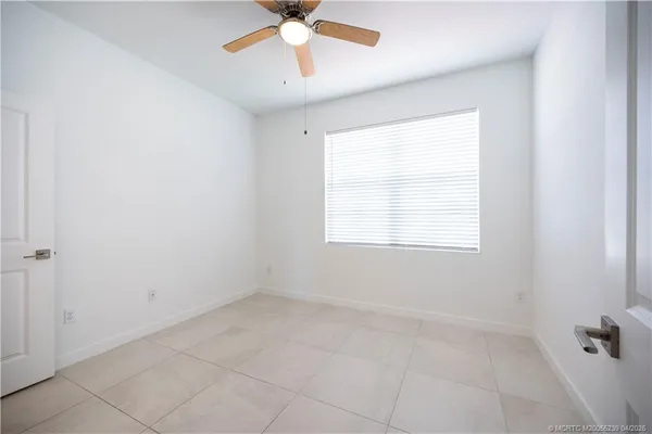 an empty room with closet and windows