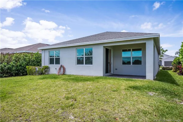 a view of a house with a yard and garage