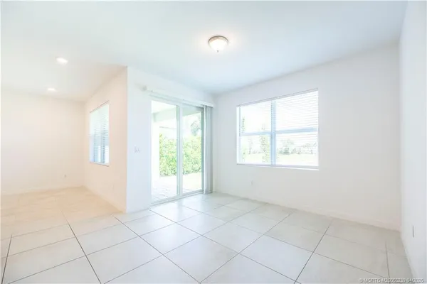 an empty room with closet and windows