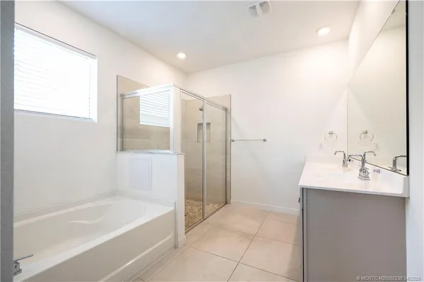 a bathroom with a sink a mirror and a bathtub