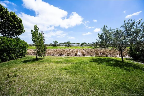 a view of a yard with a house in the background