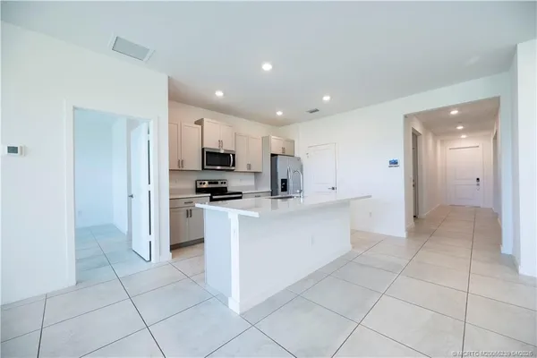 a kitchen with stainless steel appliances granite countertop a refrigerator and a sink