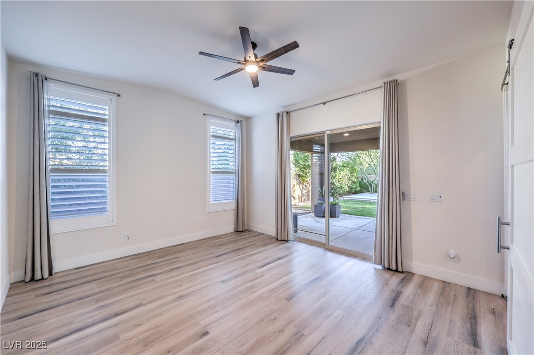 9655 Skye Star Avenue Las Vegas, NV 89166 - Photo 13 of 46 Spare room with healthy amount of natural light, light wood-style floors, and ceiling fan