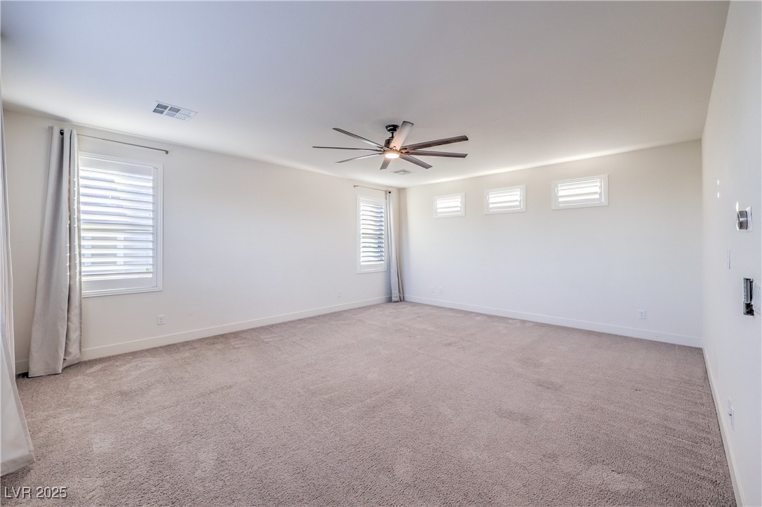 9655 Skye Star Avenue Las Vegas, NV 89166 - Photo 19 of 46 Unfurnished room with light colored carpet and a ceiling fan