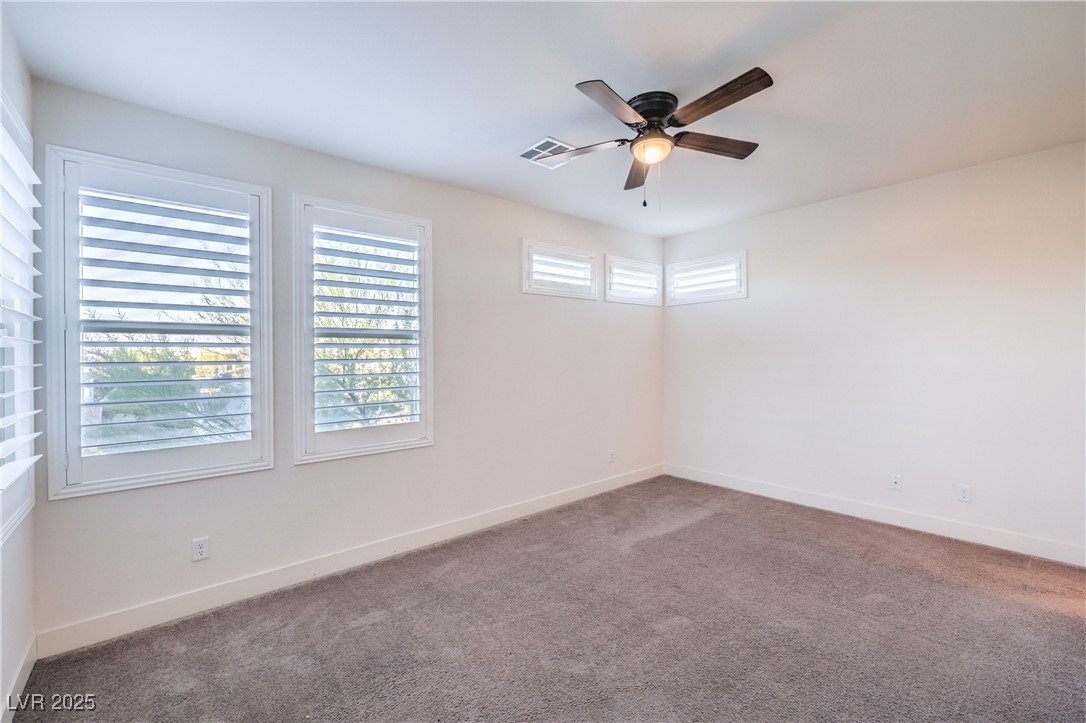 9655 Skye Star Avenue Las Vegas, NV 89166 - Photo 20 of 46 Carpeted empty room with baseboards and a ceiling fan