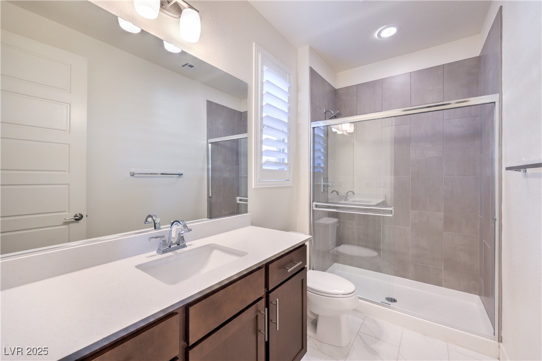 9655 Skye Star Avenue Las Vegas, NV 89166 - Photo 21 of 46 Full bath featuring vanity, a shower stall, and light marble finish flooring