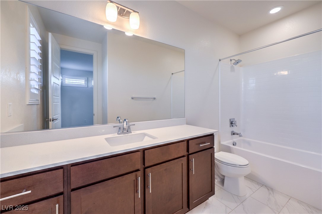 9655 Skye Star Avenue Las Vegas, NV 89166 - Photo 25 of 46 Full bathroom featuring vanity, shower combination, and light marble finish floors