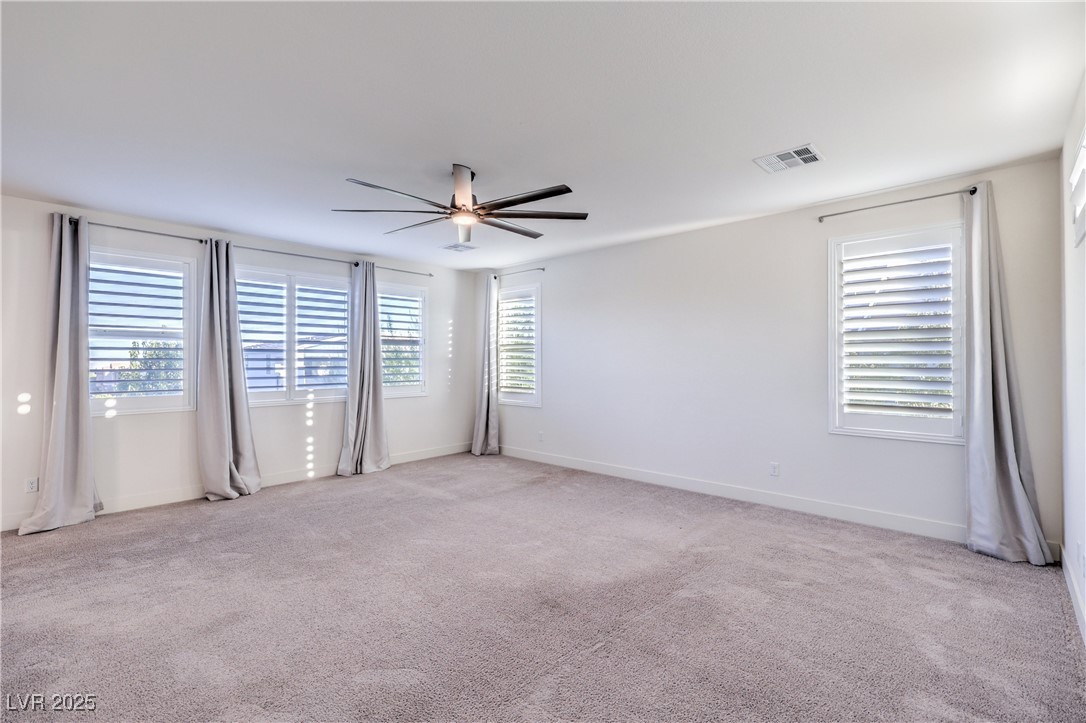 9655 Skye Star Avenue Las Vegas, NV 89166 - Photo 37 of 46 Unfurnished room with light colored carpet and a ceiling fan