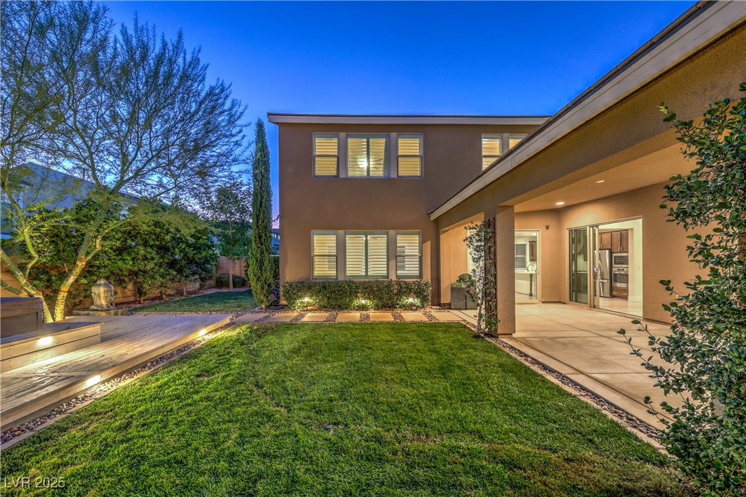 9655 Skye Star Avenue Las Vegas, NV 89166 - Photo 6 of 46 Rear view of house featuring stucco siding, a patio area, and a yard
