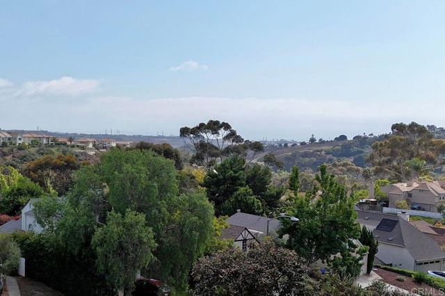 a bedroom with a bed and a large mirror