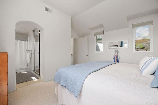 a bathroom with a double vanity sink mirror and shower