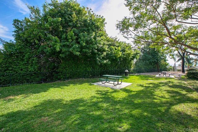 a view of a house with a small yard and plants