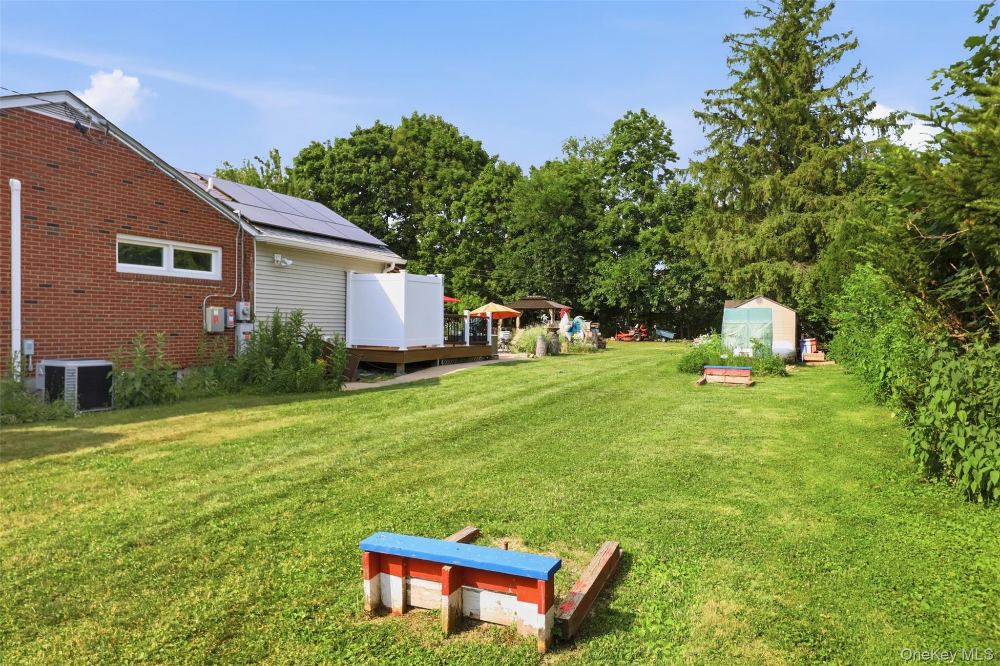 1 Hiko Place Fishkill, NY 12524 - Photo 36 of 41 Expansive green lawn with a red brick exterior and tan siding