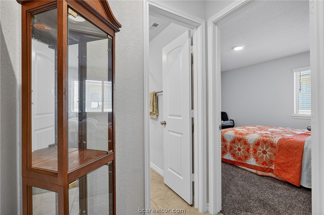 5235 Montague Loop Bryan, TX 77807 - Photo 14 of 25 a bedroom with a bed and a en suite bathroom