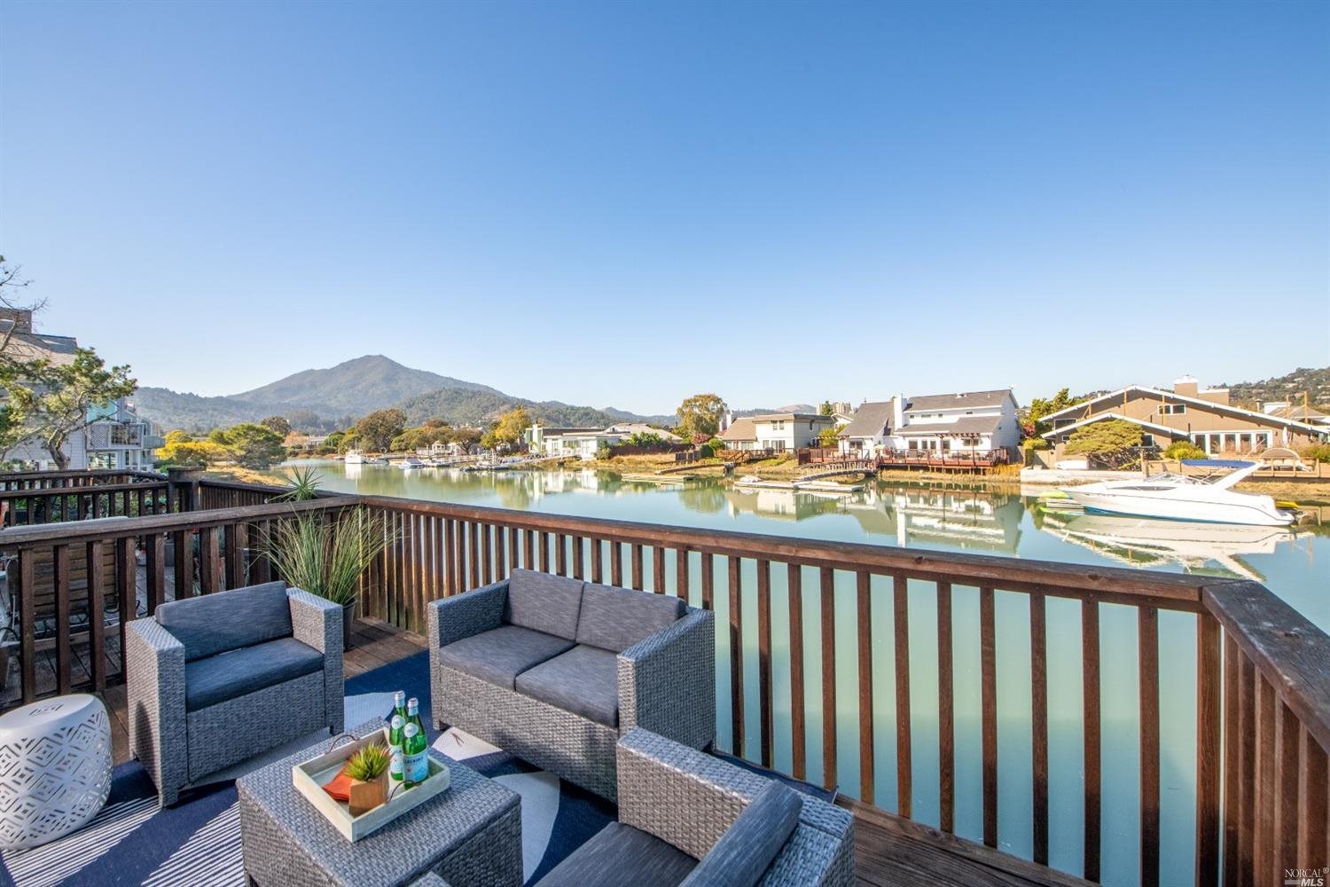 68 Lucky Drive Corte Madera, CA 94925 - Photo 1 of 1 a balcony with wooden floor outdoor seating and city view
