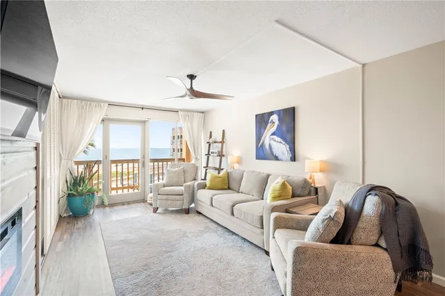 a living room with furniture and a floor to ceiling window