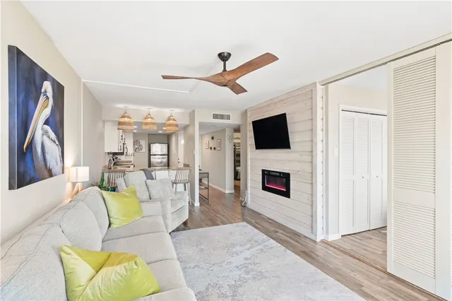 a living room with furniture flat screen tv and a fireplace
