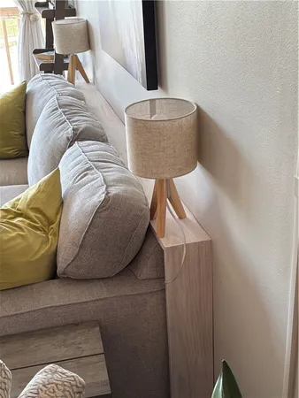 a living room with a couch and a potted plant