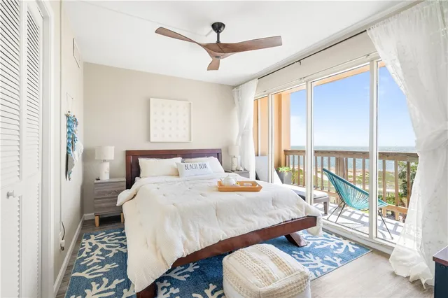 a bedroom with a bed and a large window