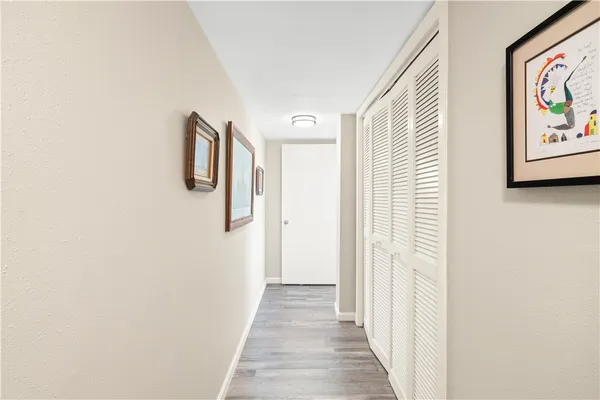 a view of a hallway with paintings on the wall