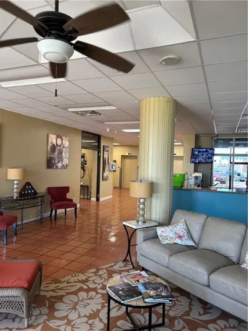 a living room with furniture a chandelier and a table