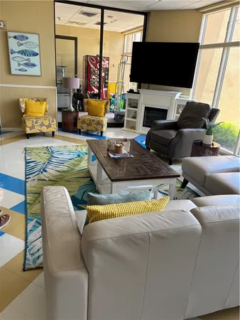 a living room with furniture a fireplace and a flat screen tv