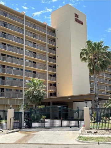 a front view of a building with a garden