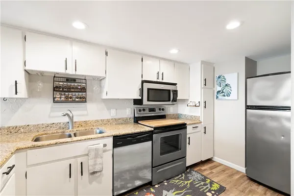 a kitchen with a sink appliances and cabinets