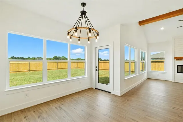 a view of a room with wooden floor and windows