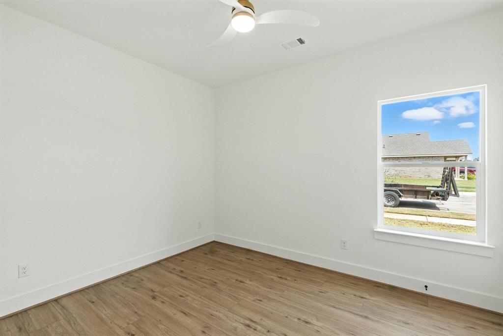421 Jameson Springtown, TX 76082 - Photo 25 of 37 an empty room with wooden floor and windows