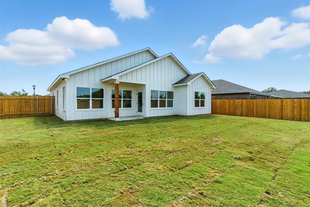 421 Jameson Springtown, TX 76082 - Photo 33 of 37 a view of a house with a garden