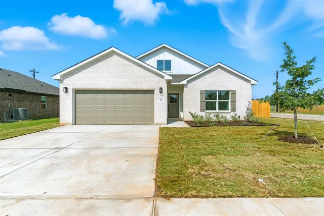 a view of an house with backyard space and balcony