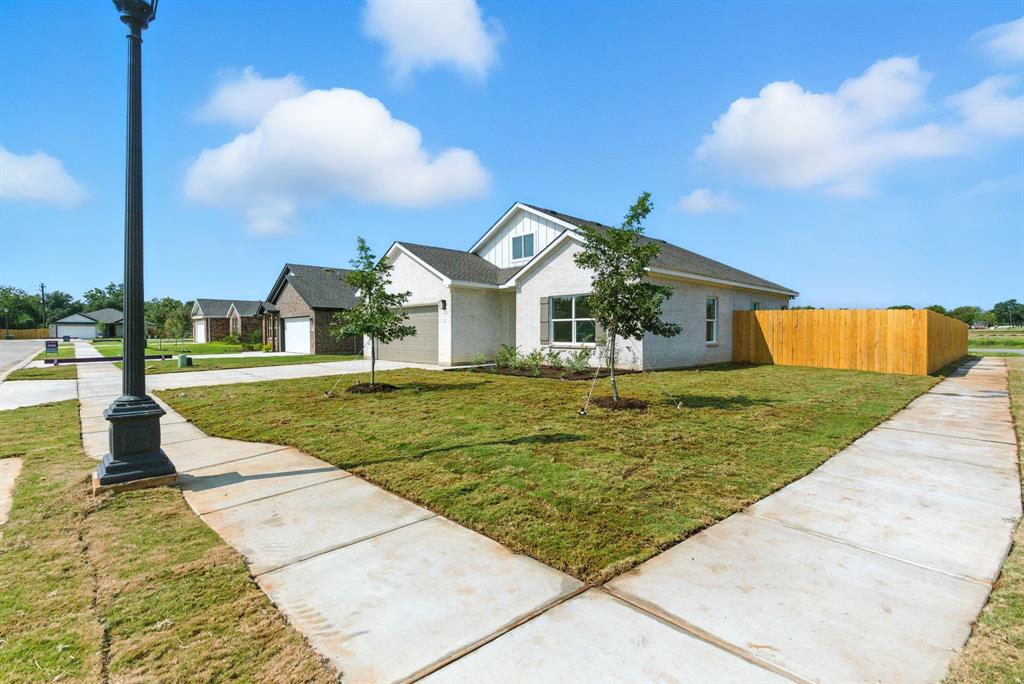 421 Jameson Springtown, TX 76082 - Photo 37 of 37 a front view of a house with a yard