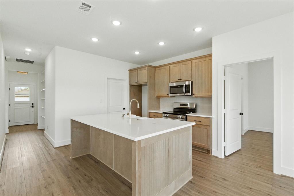 421 Jameson Springtown, TX 76082 - Photo 5 of 37 a kitchen with a sink stove and refrigerator