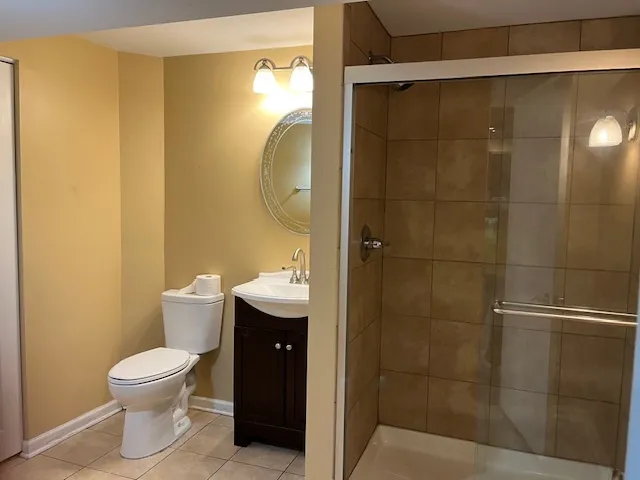 a bathroom with a toilet a sink and a shower