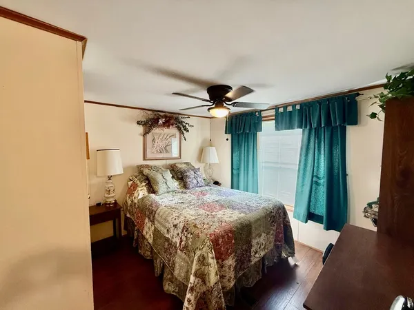 a bedroom with a bed and a mirror