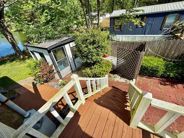 a view of balcony with wooden floor and outdoor seating