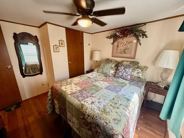 a bedroom with a bed and a mirror