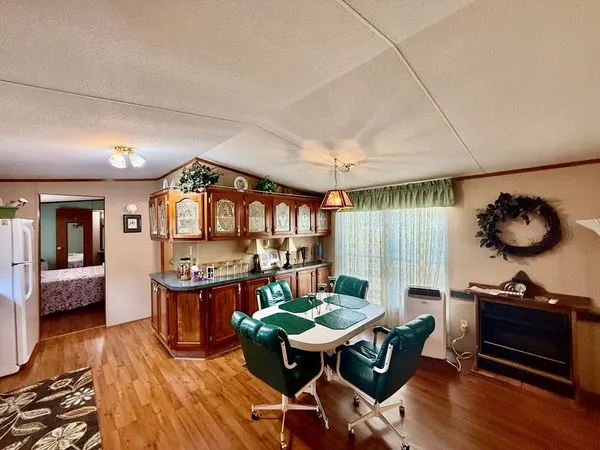 a view of a dining room with furniture and wooden floor