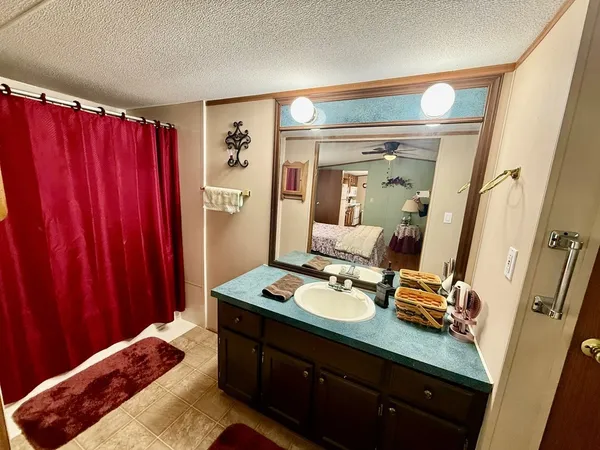 a bedroom with a bed and a mirror