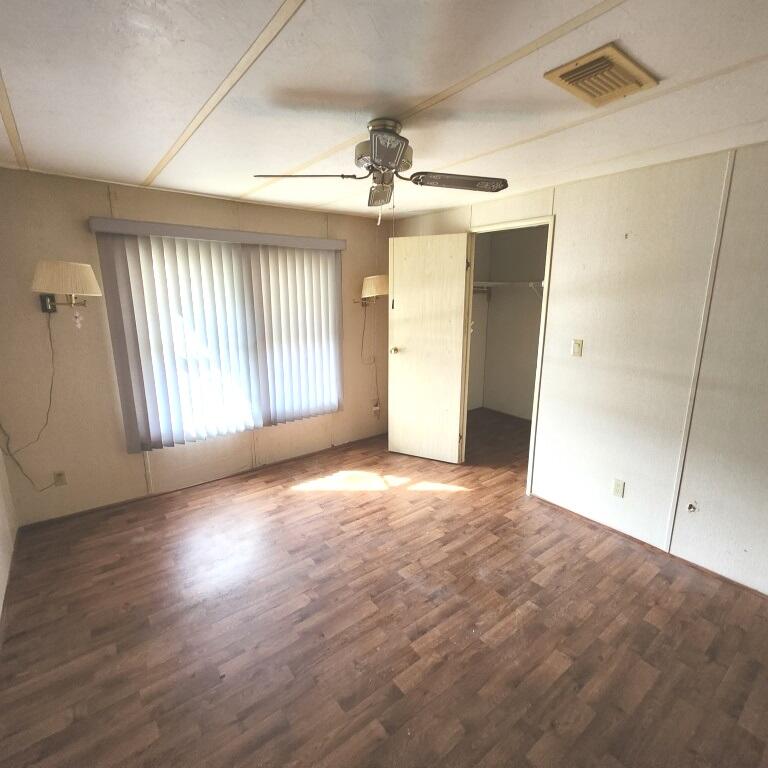 2847 Southwest Thunderbird Trail Stuart, FL 34997 - Photo 13 of 22 an empty room with wooden floor and windows